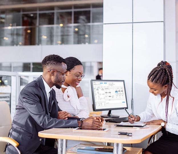 couple at desk with salesperson